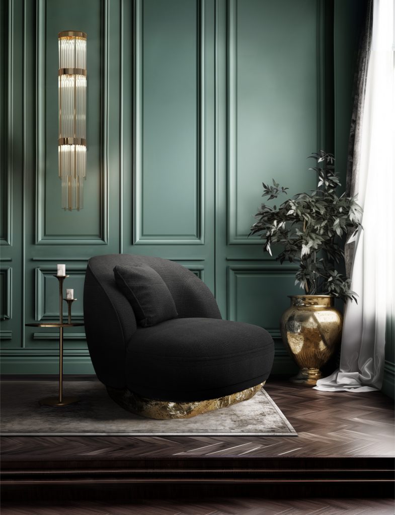 Vintage Inspired- A living room with a black armchair also with a golden brass underneath and candles on the left side. 
There's also a big golden vase on the right side with curtains. Blue wood wall.