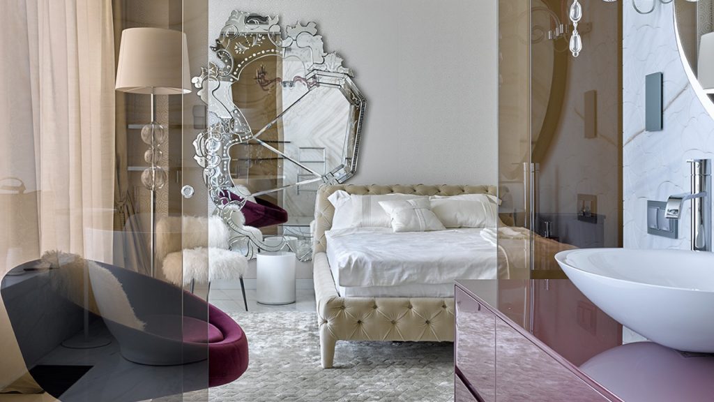 contemporary- A bedroom with a beige bed, seeing by the entryway. There's a big scratched miroor on the wall