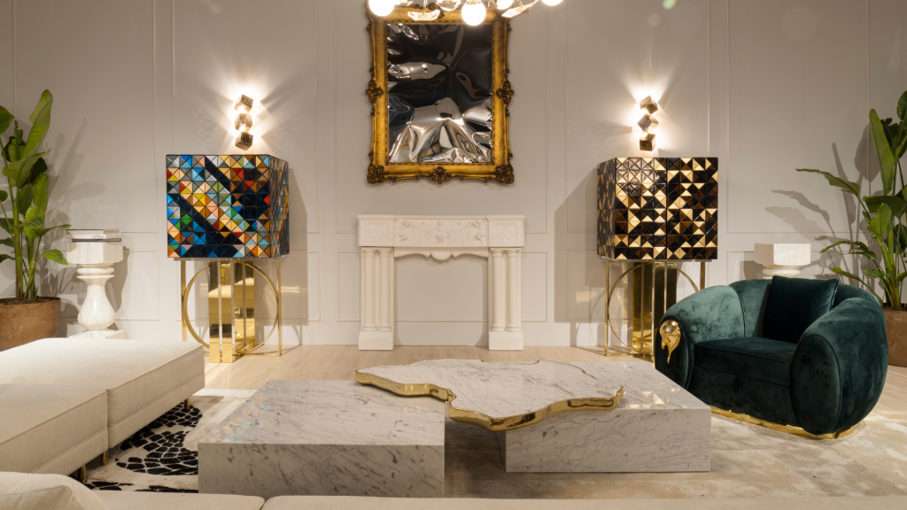 Boca do Lobo- A living room with a big cream sofa, a green armchair, a big center table, divided in 2parts, 2 different cabinets, a mirror