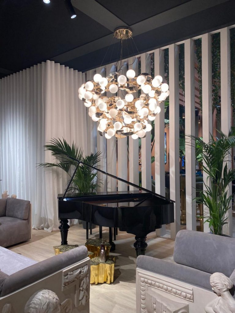 Boca do Lobo- a black piano, 3 grey sofas, 3 wood center tables